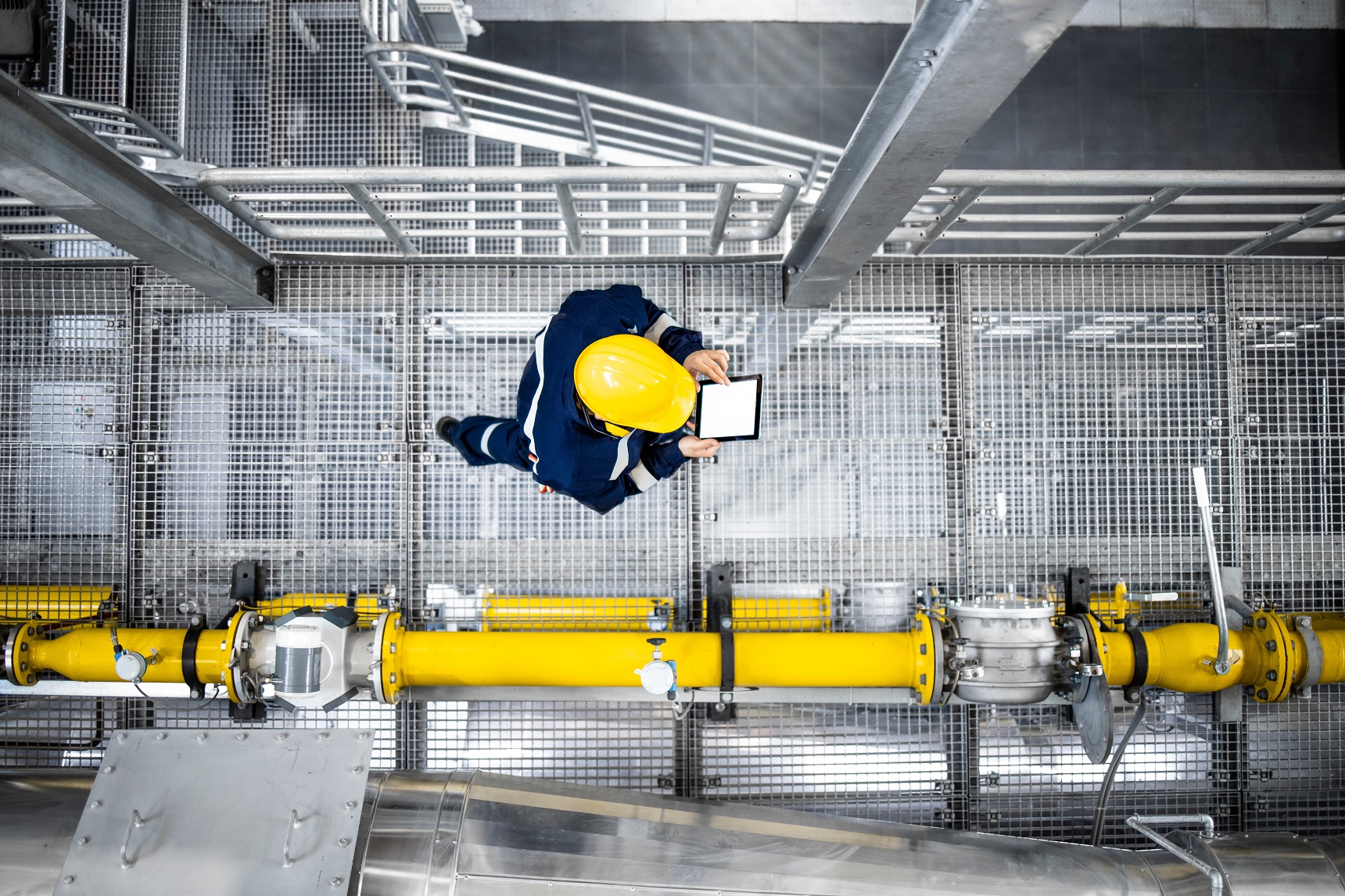 Top,View,Of,Petroleum,Refinery,Worker,Walking,By,Gas,Pipes